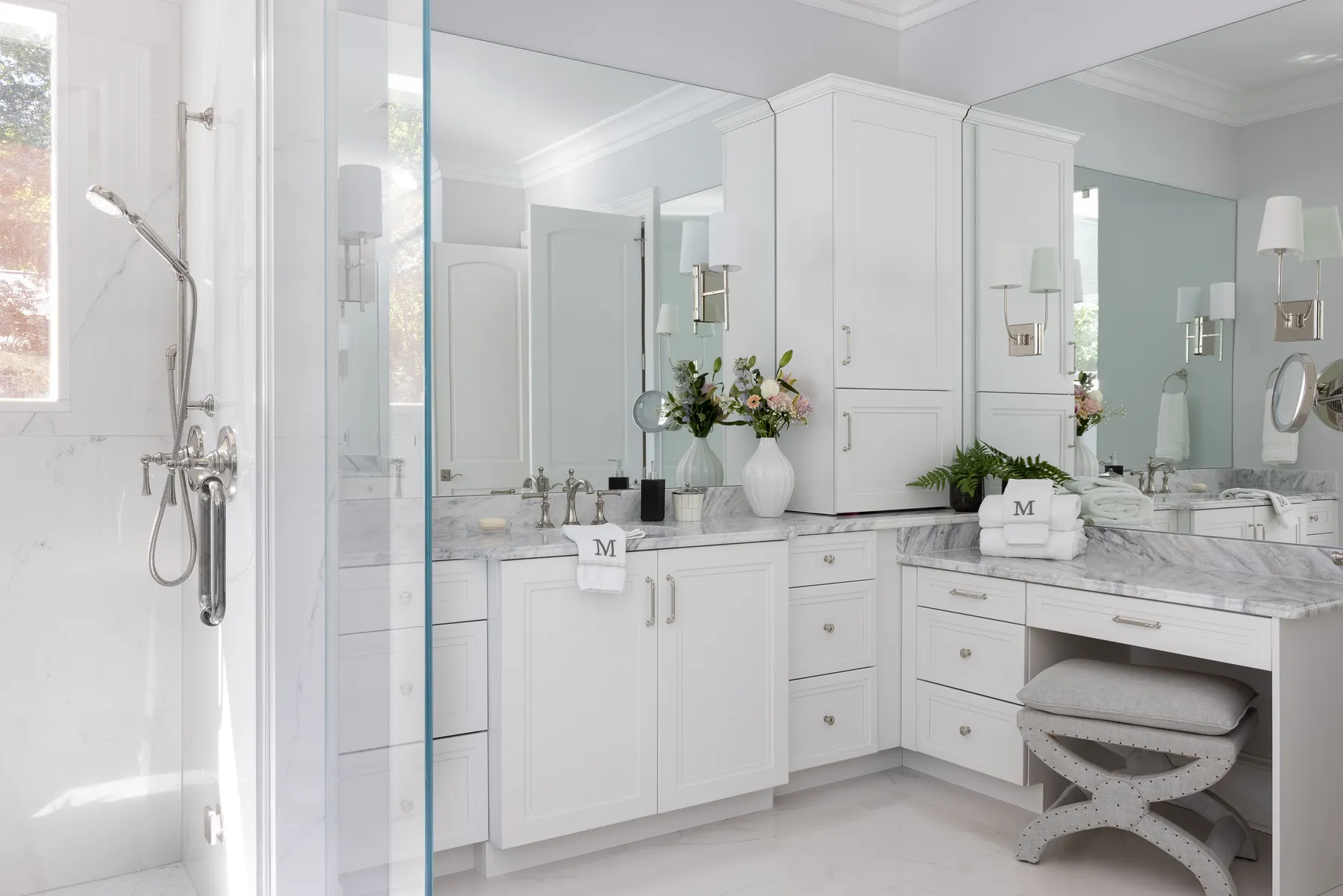 The custom vanity with a seated makeup station.