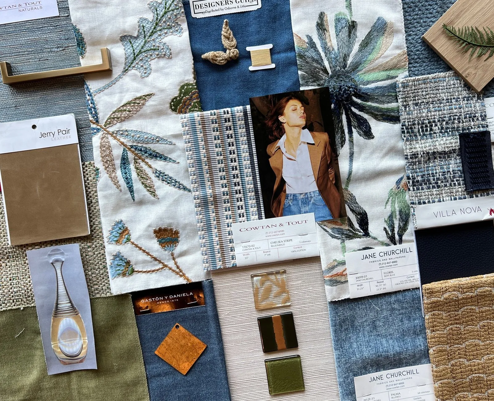 A design board: denim blues, botanicals and brass hardware.