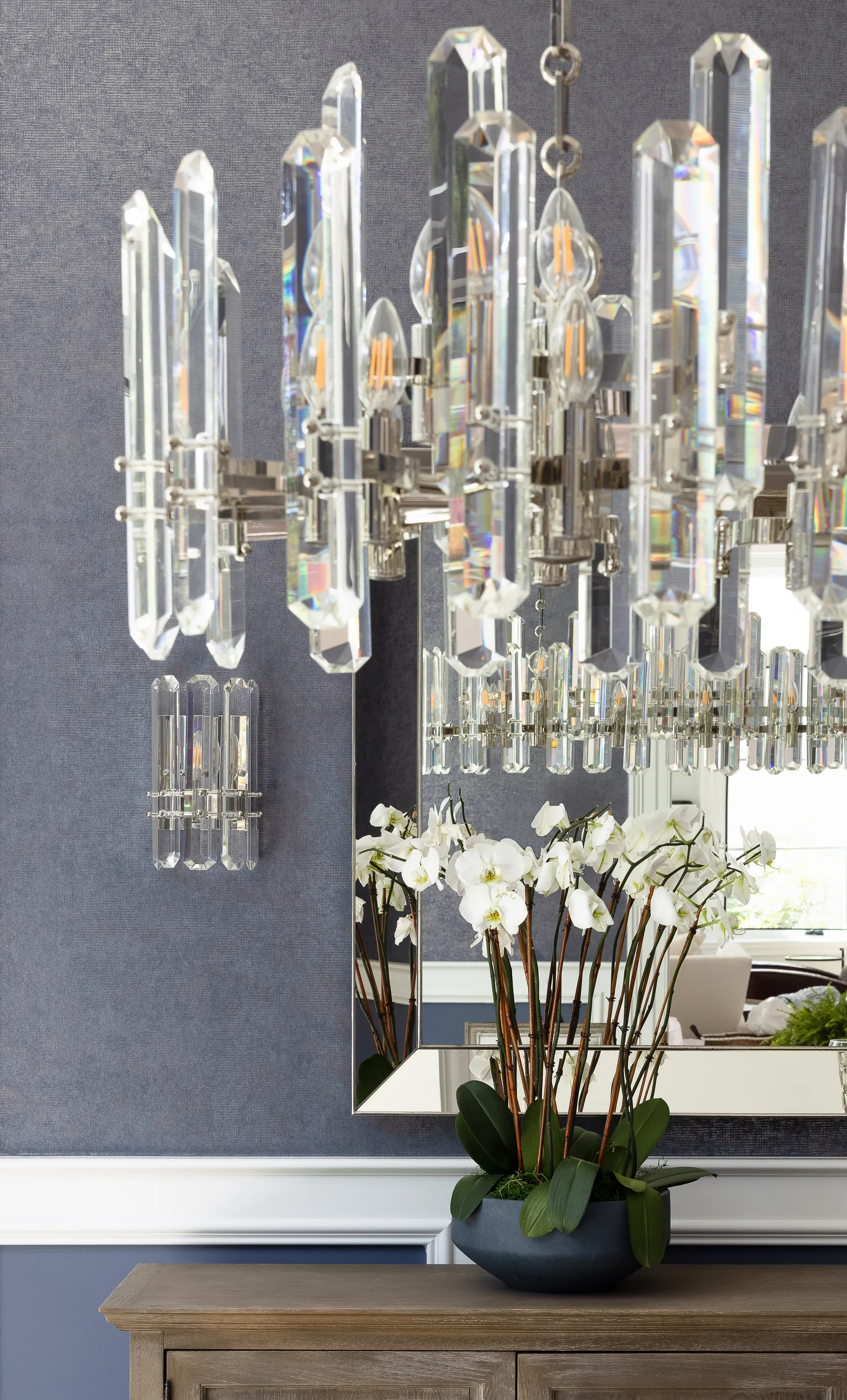The dining room chandelier against the wallpaper.