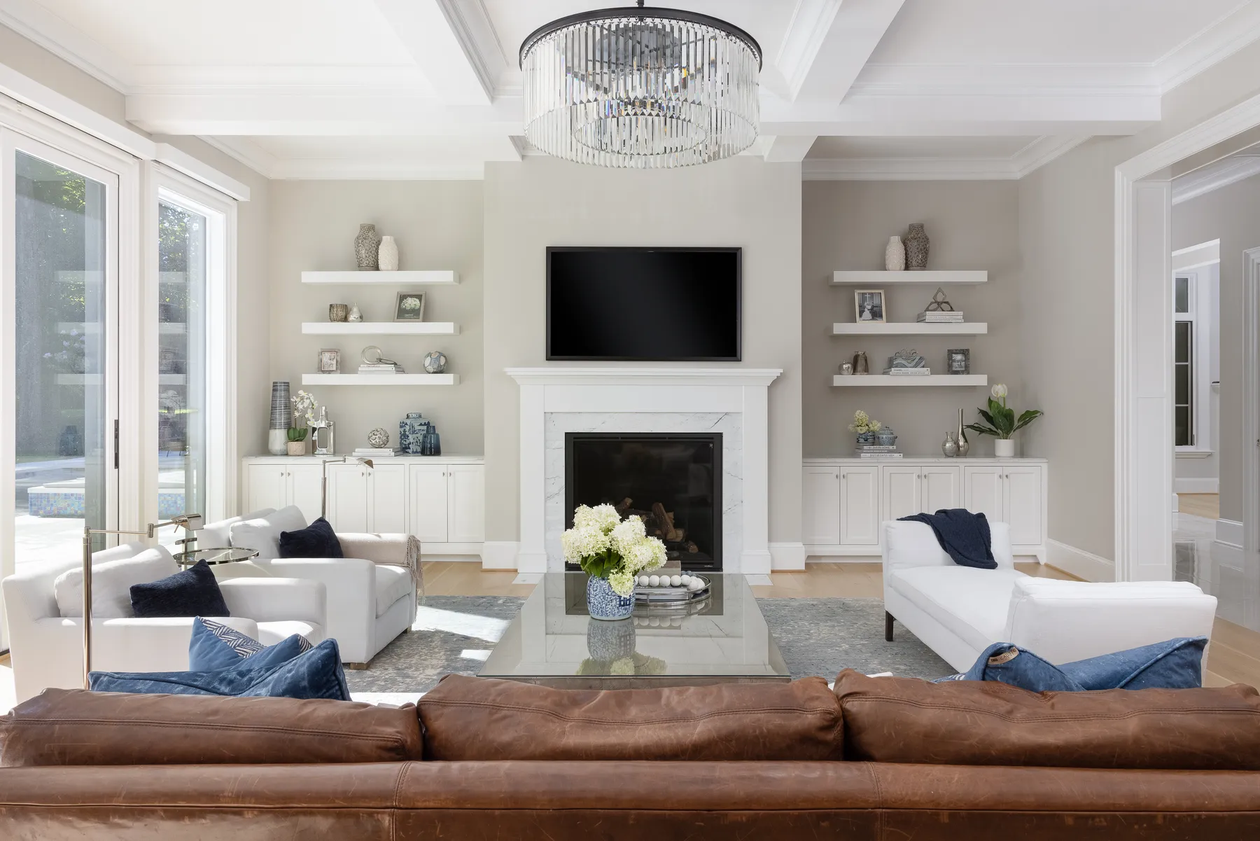 The clients' leather sofa stayed, layered with ivory upholstery and navy throws.